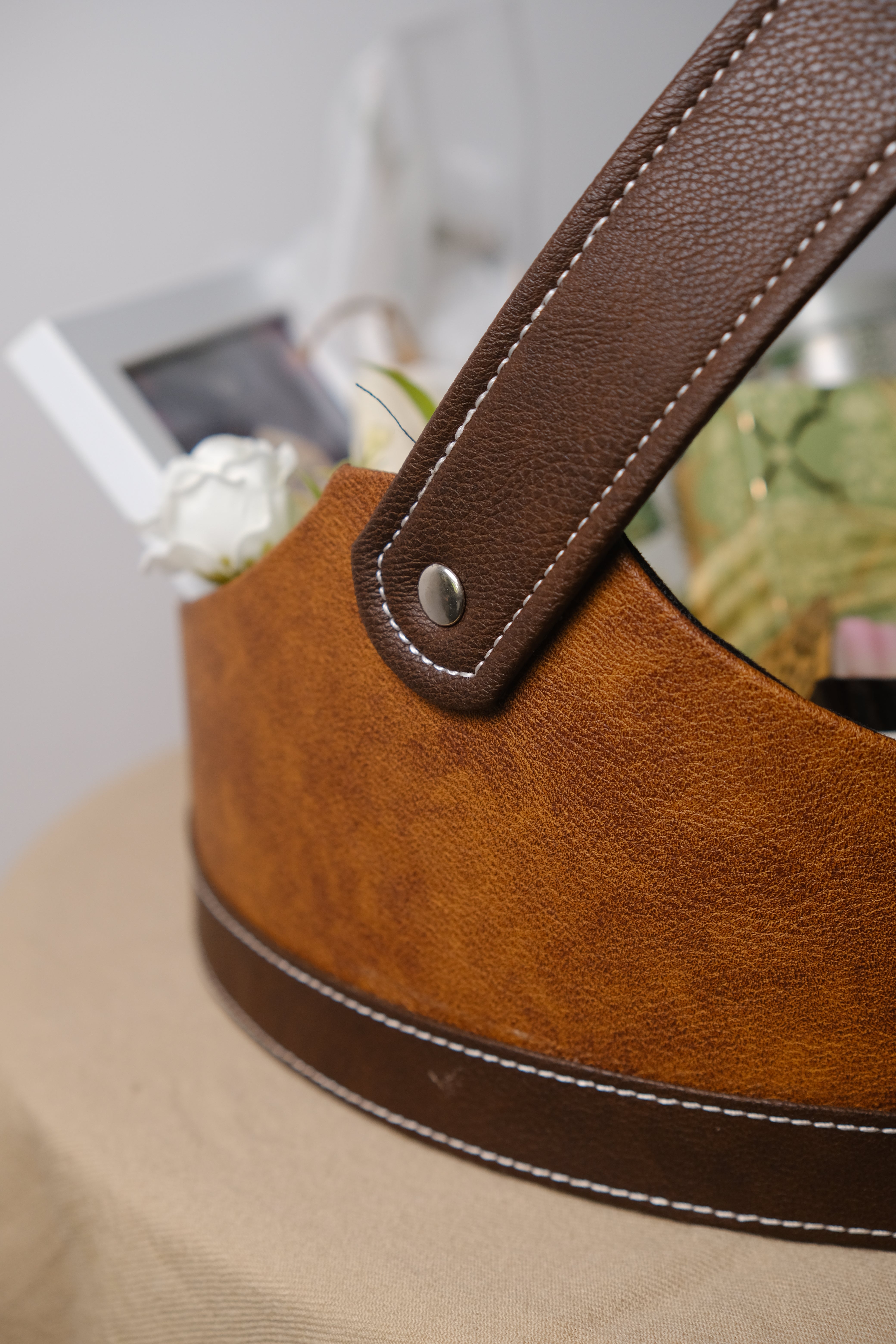 Close-up of a brown leather strap on a beige background
